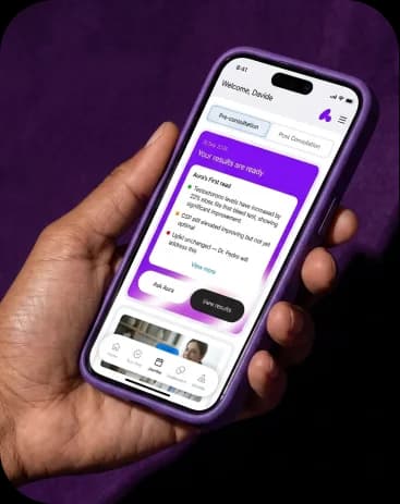 Hand holding a phone showing the nuAura app, with a card announcing that the blood test results are ready
